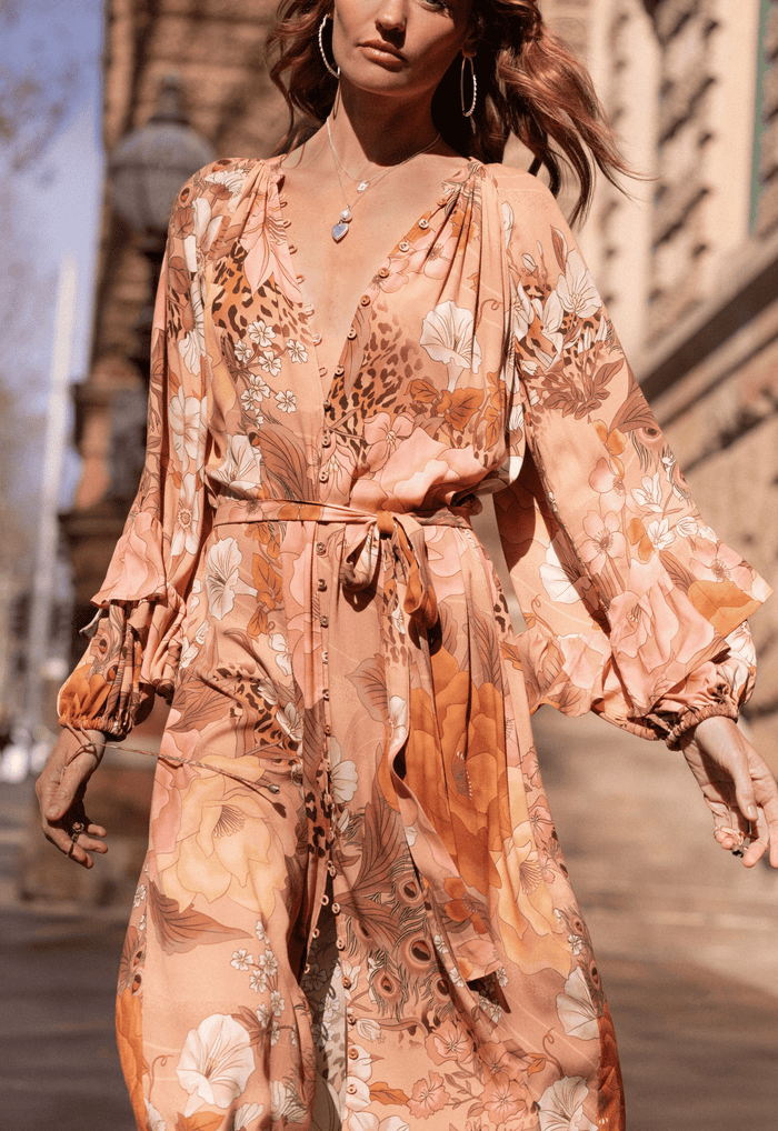 Front model shot of rose quartz floral viscose gown, ruffle long sleeves, elastic cuffs, button front and waist tie