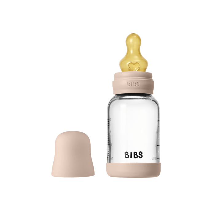 BIBS Glass Baby Bottle 120ml in Blush with yellow latex teat and removable cap on white background