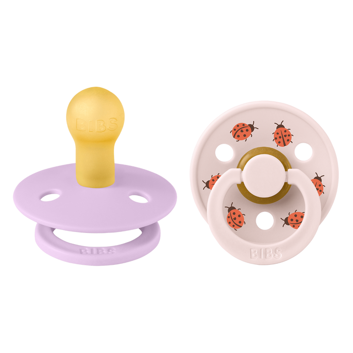BIBS Studio Colour 2 Pack Ladybug pacifiers: violet sky purple and blush pink with red ladybug print, white background