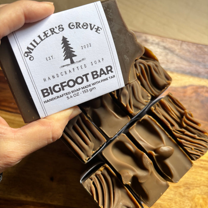 Handmade soap bar with a visible label on a wooden surface