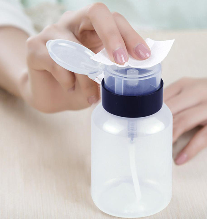 Hand pressing Blush Clear Pump Dispenser 200ml with cotton pad, demonstrating no-spill application for toner, remover, or acetone