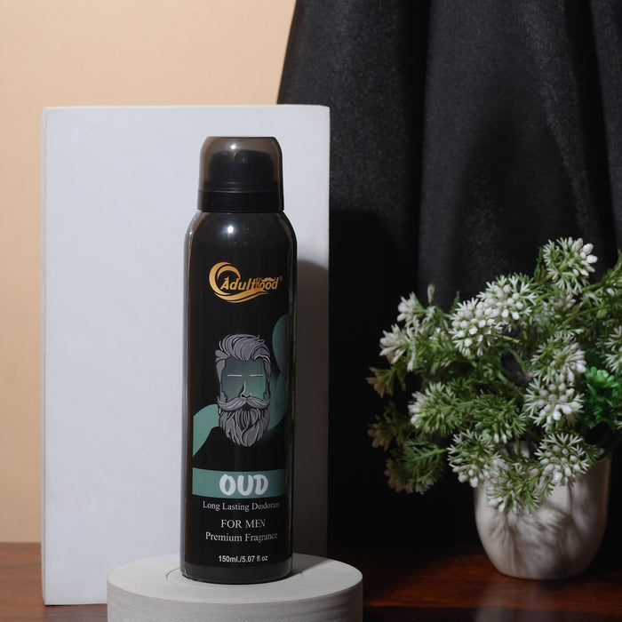 Black deodorant spray bottle with brand logo on a white platform, against a neutral background with a plant.