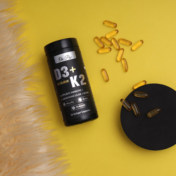 Black supplement bottle labeled D3+K2 with scattered capsules on a yellow background